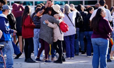 Parents reunite with their children outside Hinkley High School in Aurora