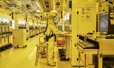 Technicians perform production control tasks at the implant zone in the cleanroom at Fab7 in the Globalfoundries Inc. semiconductor fabrication (fab) facility in Singapore