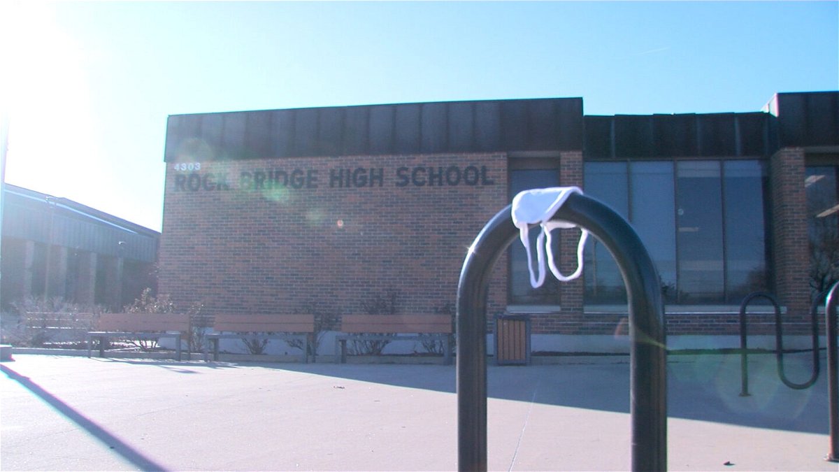 A discarded mask sits on a rack outside Rock Bridge High School