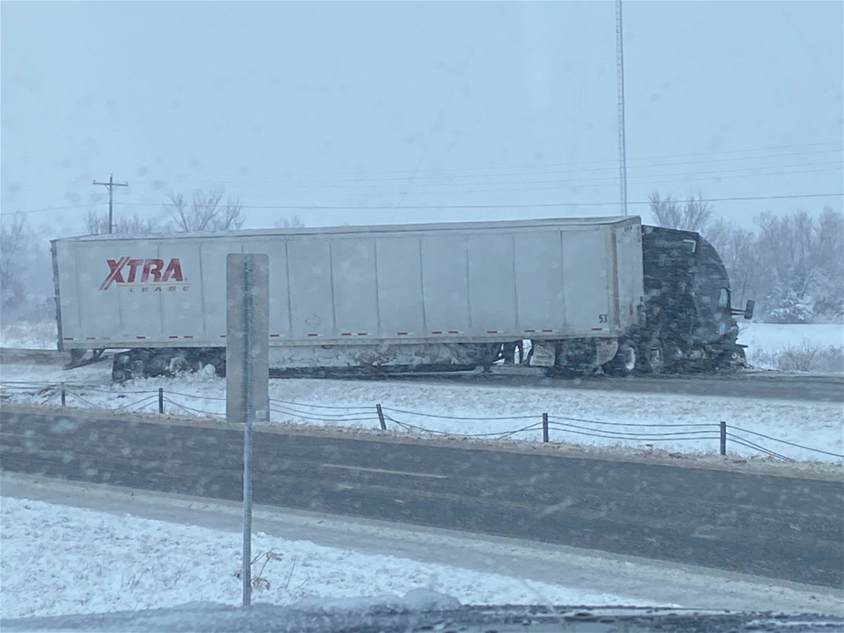A tractor-trailer sits after sliding off I-70 near the Millersburg exit east of Columbia on Saturday, Jan. 15, 2022.