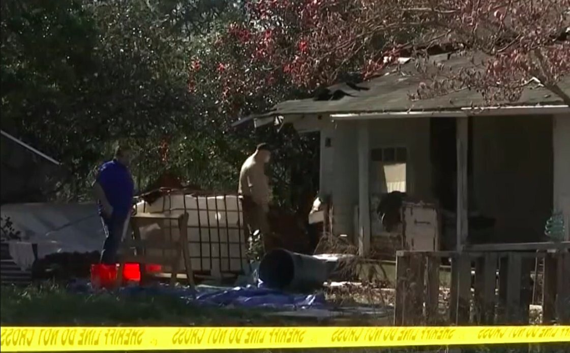 <i>WALA</i><br/>Mobile County Sheriff's Office investigators are seen at a Lott Road home were a body was found buried beneath the floorboards.