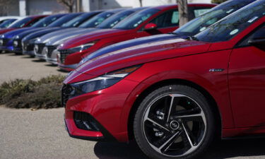 A long row of unsold 2021 Sonata sedans sits at a Hyundai dealership