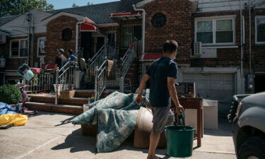 Queens residents sort through damaged and destroyed items after the remnants of Hurricane Ida swept through New York City and flooded homes in September.