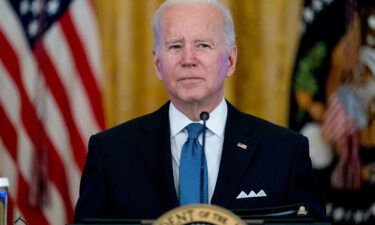 President Joe Biden listens to reporter's questions during a meeting on efforts to lower prices for working families