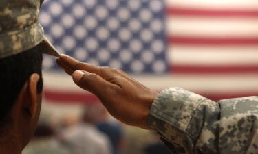 A soldier salutes the flag during a welcome home ceremony for troops arriving from Afghanistan on June 15