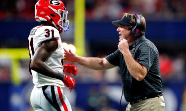 Head Coach Kirby Smart of the Georgia Bulldogs talks to William Poole #31 of the Georgia Bulldogs in the second quarter of the SEC Championship game against the aAlabama Crimson Tide at Mercedes-Benz Stadium on December 4