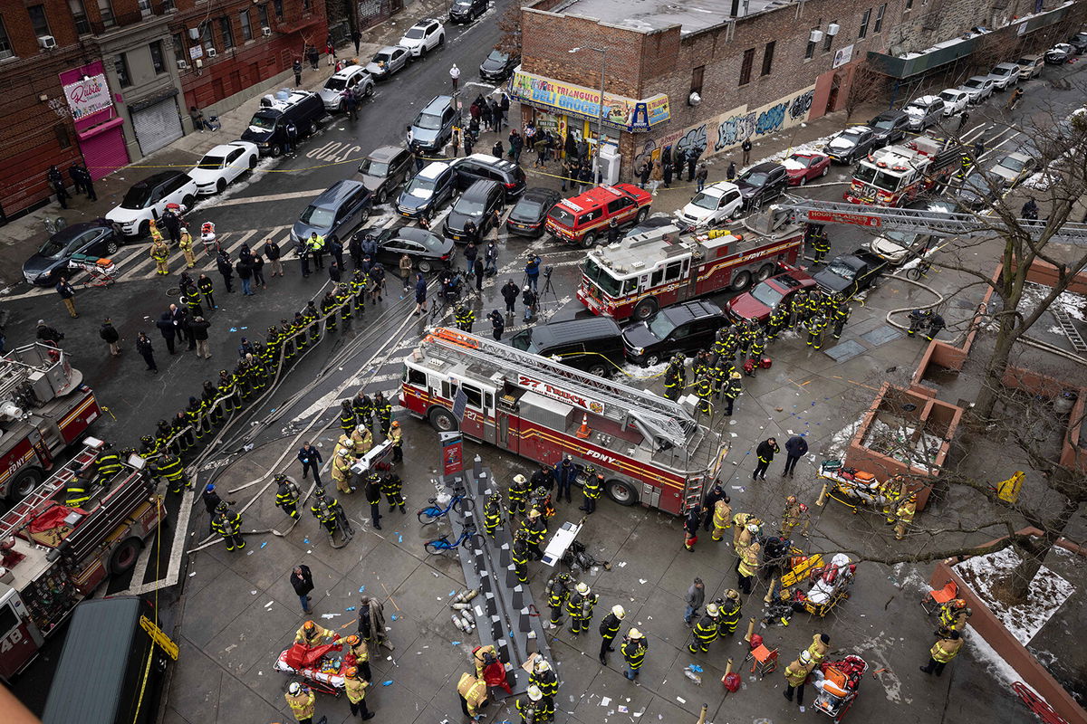 <i>Yuki Iwamura/AP</i><br/>Firefighters work outside an apartment building after a fire in the Bronx