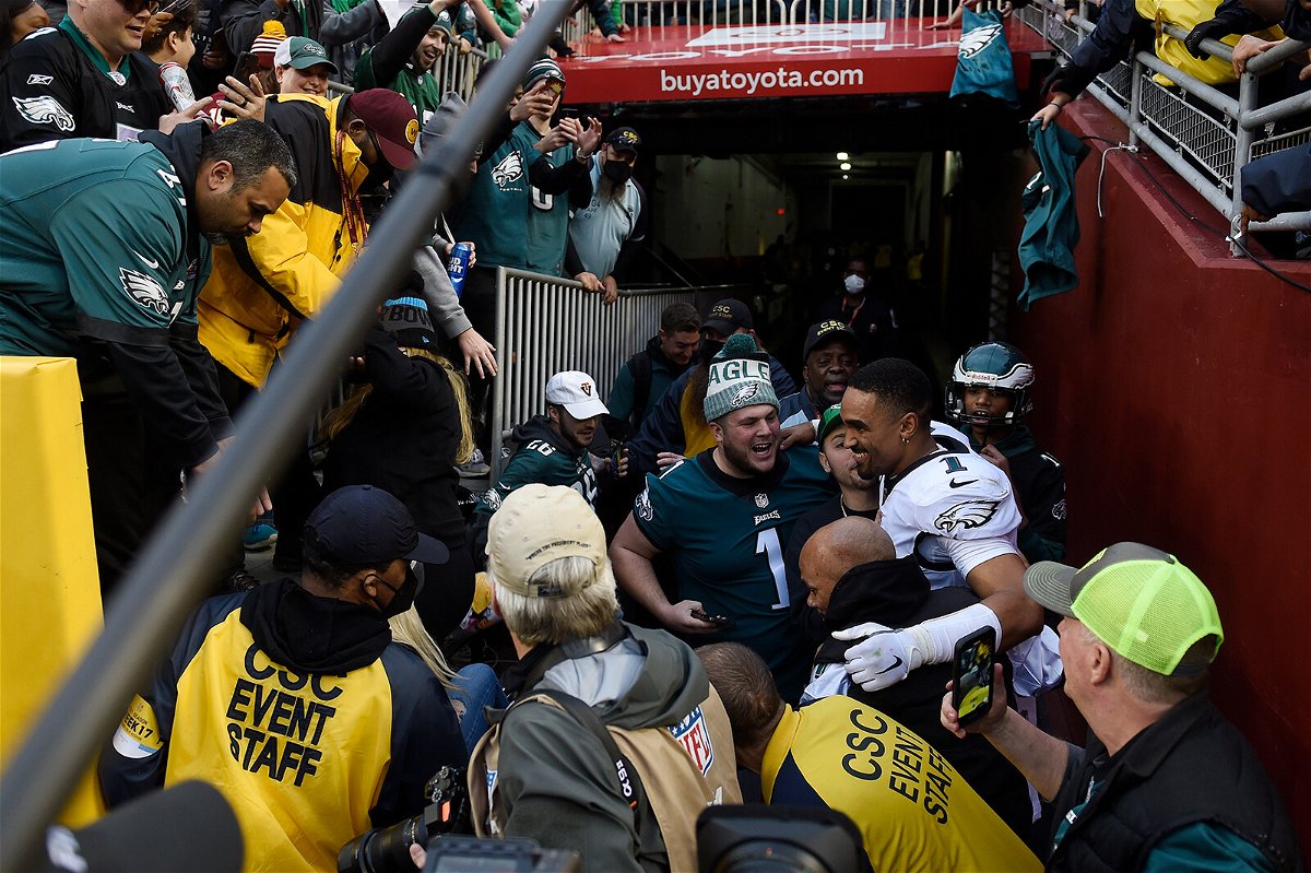 <i>Greg Fiume/Getty Images</i><br/>Philadelphia Eagles quarterback Jalen Hurts celebrates with fans who fell onto the ground after the railing collapsed.