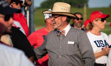 Douglas Frank talks with others before former President Donald Trump arrives to speak at a rally on June 26