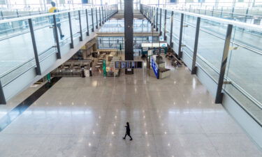 A staff member walks through the deserted arrivals hall at Hong Kong airport on November 29