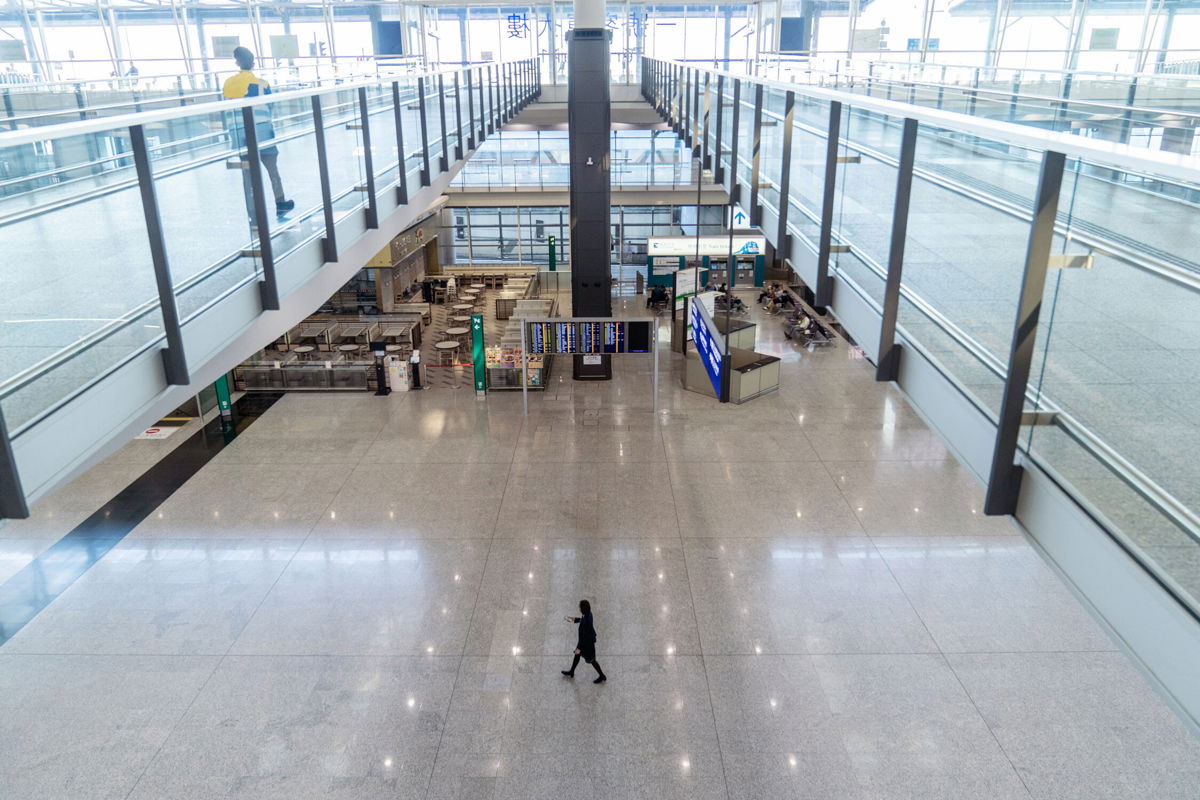 <i>Chan Long Hei/Bloomberg/Getty Images</i><br/>A staff member walks through the deserted arrivals hall at Hong Kong airport on November 29