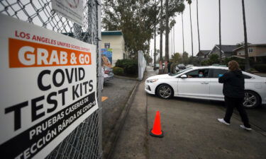 Los Angeles Unified School District staff distribute free Covid-19 test kits to local families on Friday