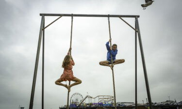 Two children climbing on ropes in California
