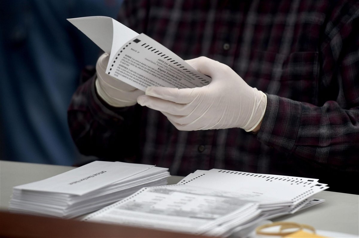 <i>Aimee Dilger/SOPA Images/LightRocket via Getty Images</i><br/>Mail-in ballots are opened to be counted in Luzerne County