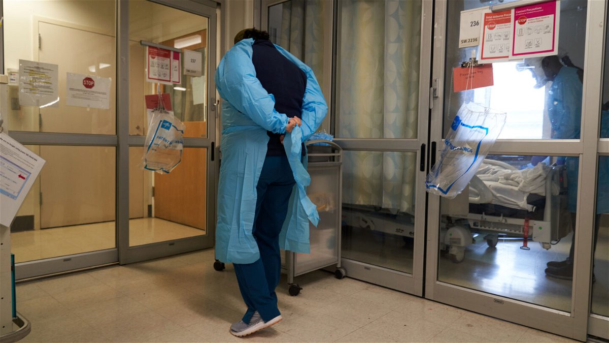 <i>Allison Dinner/Bloomberg via Getty Images</i><br/>A healthcare worker puts on PPE on the Covid-19 ICU floor of the University of Massachusetts (UMass) Memorial Hospital in Worcester