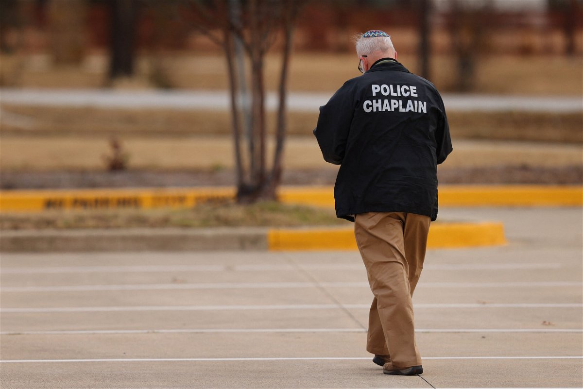 <i>Andy Jcobsohn/AFP/Getty Images</i><br/>A police chaplain walks near the Congregation Beth Israel synagogue in Colleyville