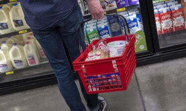 A customer holds a basket while shopping at a grocery store in San Francisco in 2021.