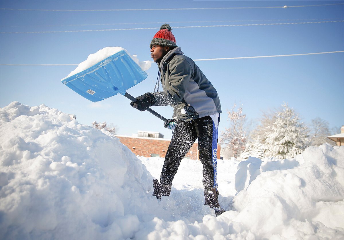<i>Bryon Houlgrave /AP</i><br/>Bonny Obutu shovels snow off his sidewalk in West Des Moines