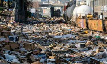 Shredded boxes and packages are seen at a section of the Union Pacific train tracks in downtown Los Angeles on