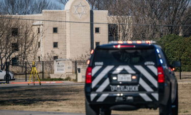 A law enforcement vehicle sits near the Congregation Beth Israel synagogue on Sunday