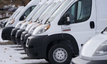 A long row of unsold 2021 Promaster vans sits at a Ram dealership Sunday