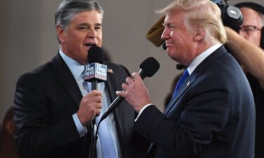 Fox News Channel and radio talk show host Sean Hannity (L) interviews U.S. President Donald Trump before a campaign rally at the Las Vegas Convention Center on September 20