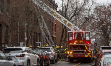 The Philadelphia Fire Department works at the scene of a deadly row house fire in Philadelphia on Wednesday.