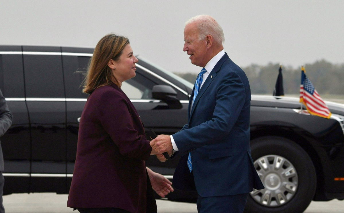 <i>NICHOLAS KAMM/AFP/Getty Images</i><br/>Democratic Rep. Elissa Slotkin greets Biden in Michigan in October 2021.