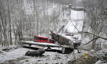 A Pittsburgh Port Authority bus that was on a bridge when it collapsed Friday is visible in the city's East End.