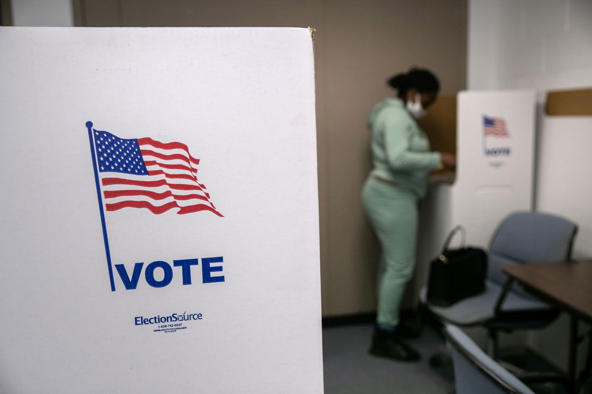 <i>John Moore/Getty Images</i><br/>A voter fills out her ballot on the last day of early voting at the Lansing City Clerk's office on November 2