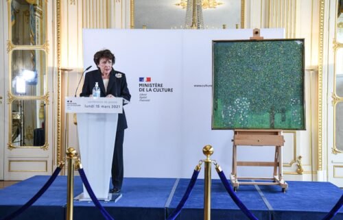 French Culture Minister Roselyne Bachelot stands next to a Nazi-pillaged artwork