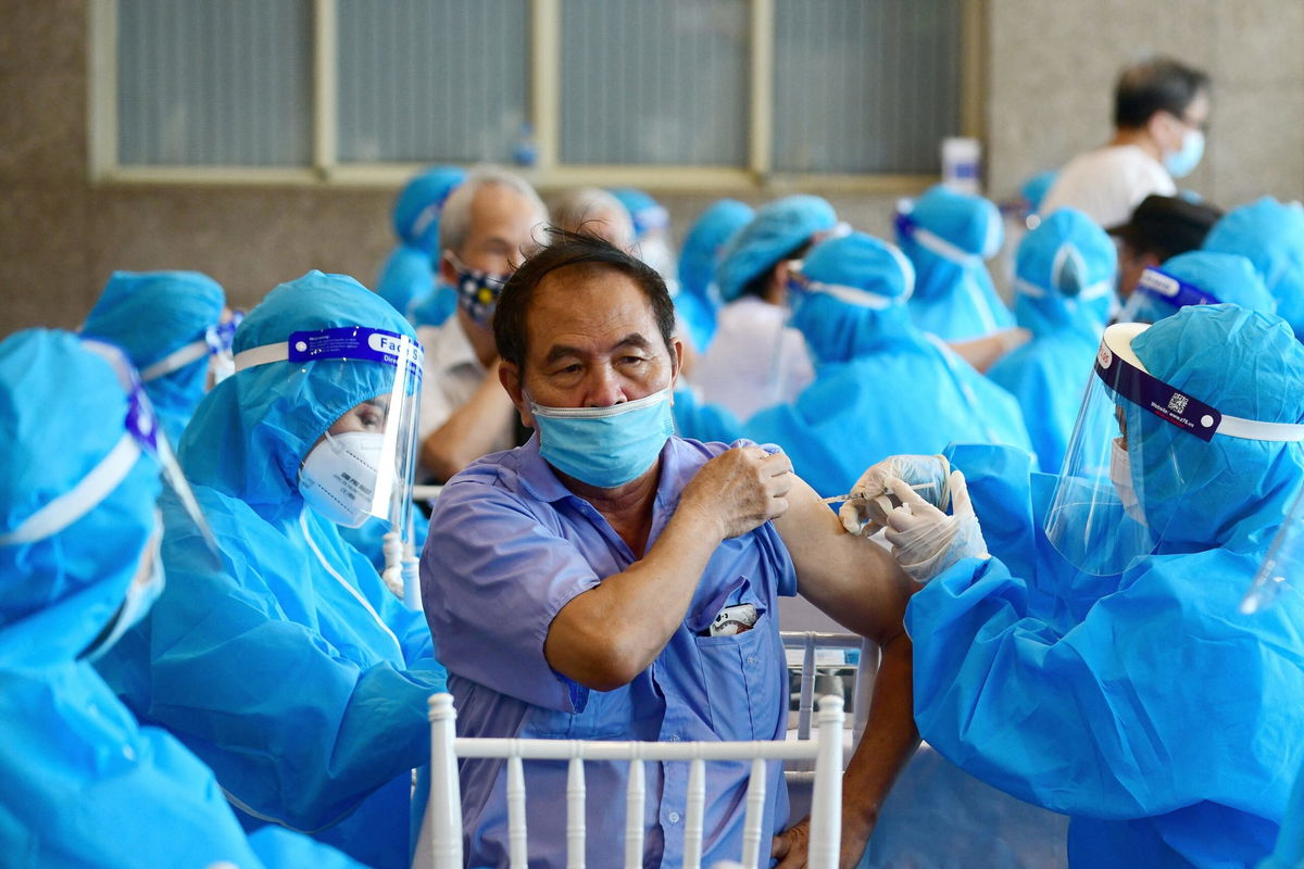 <i>Nhac Nguyen/AFP/Getty Images</i><br/>A man receives the AstraZeneca Covid-19 coronavirus vaccine in Hanoi on September 10