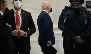 US President Joe Biden (C) arrives to meet with the Senate Democratic Caucus on Capitol Hill in Washington