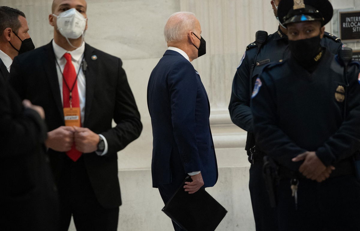 <i>SAUL LOEB/AFP/Getty Images</i><br/>US President Joe Biden (C) arrives to meet with the Senate Democratic Caucus on Capitol Hill in Washington