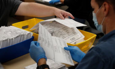 Election officials and volunteers process ballots for counting during the 2020 Presidential election in Provo