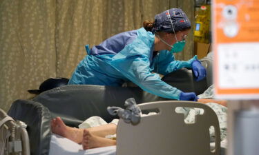 A nurse tends to a patient in the acute care unit of Harborview Medical Center in Seattle on Friday