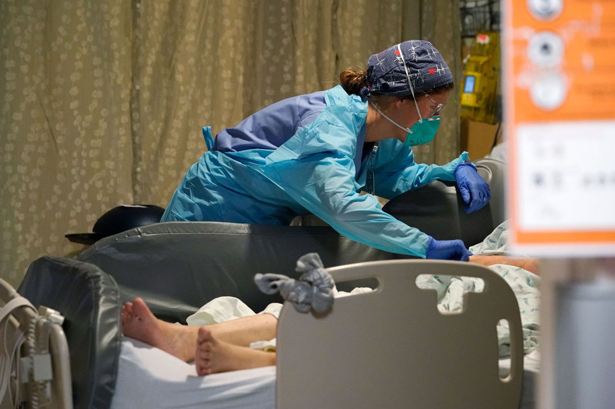 <i>Elaine Thompson/AP</i><br/>A nurse tends to a patient in the acute care unit of Harborview Medical Center in Seattle on Friday