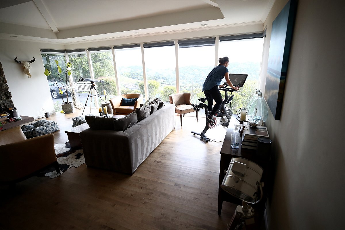 <i>Ezra Shaw/Getty Images</i><br/>A person rides her Peloton exercise bike at her home on April 06