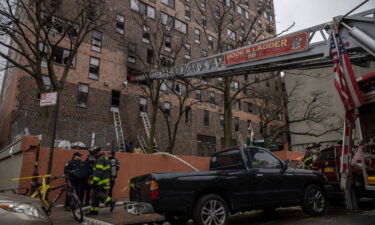 Emergency personnel work at the scene of the fatal fire on Sunday.