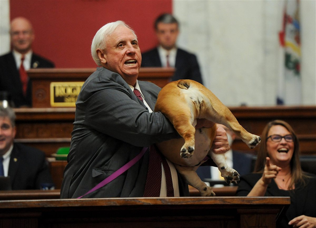 <i>Chris Dorst/Charleston Gazette-Mail/AP</i><br/>West Virginia Gov. Jim Justice holds up his dog Babydog's rear end as a message to people who've doubted the state as he comes to the end of his State of the State speech in the House chambers