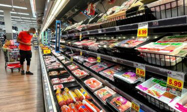 A person shops in the meat section of a grocery store on November 11