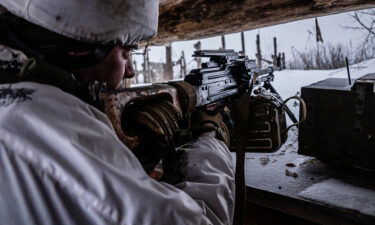 Ukrainian soldiers walk through a destroyed industrial zone that is in some areas