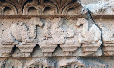 Artwork on a temple in northern Iraq depicts hybrid camels flanking a royal figure.