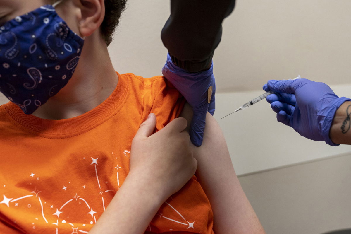 <i>Nick Oxford/Bloomberg/Getty Images</i><br/>A health care worker administers a dose of the Pfizer-BioNTech Covid-19 vaccine to a child in Oklahoma City in 2021.