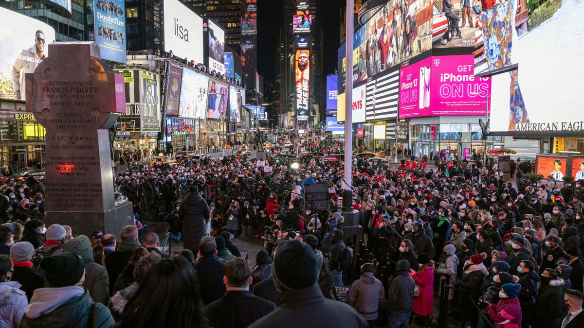 <i>Yuki Iwamura/AP</i><br/>People gathered for a candlelight vigil in honor of Michelle Alyssa Go on Tuesday in Times Square.