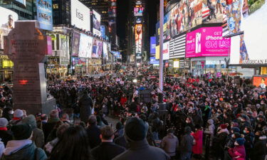 People gathered for a candlelight vigil in honor of Michelle Alyssa Go on Tuesday in Times Square.