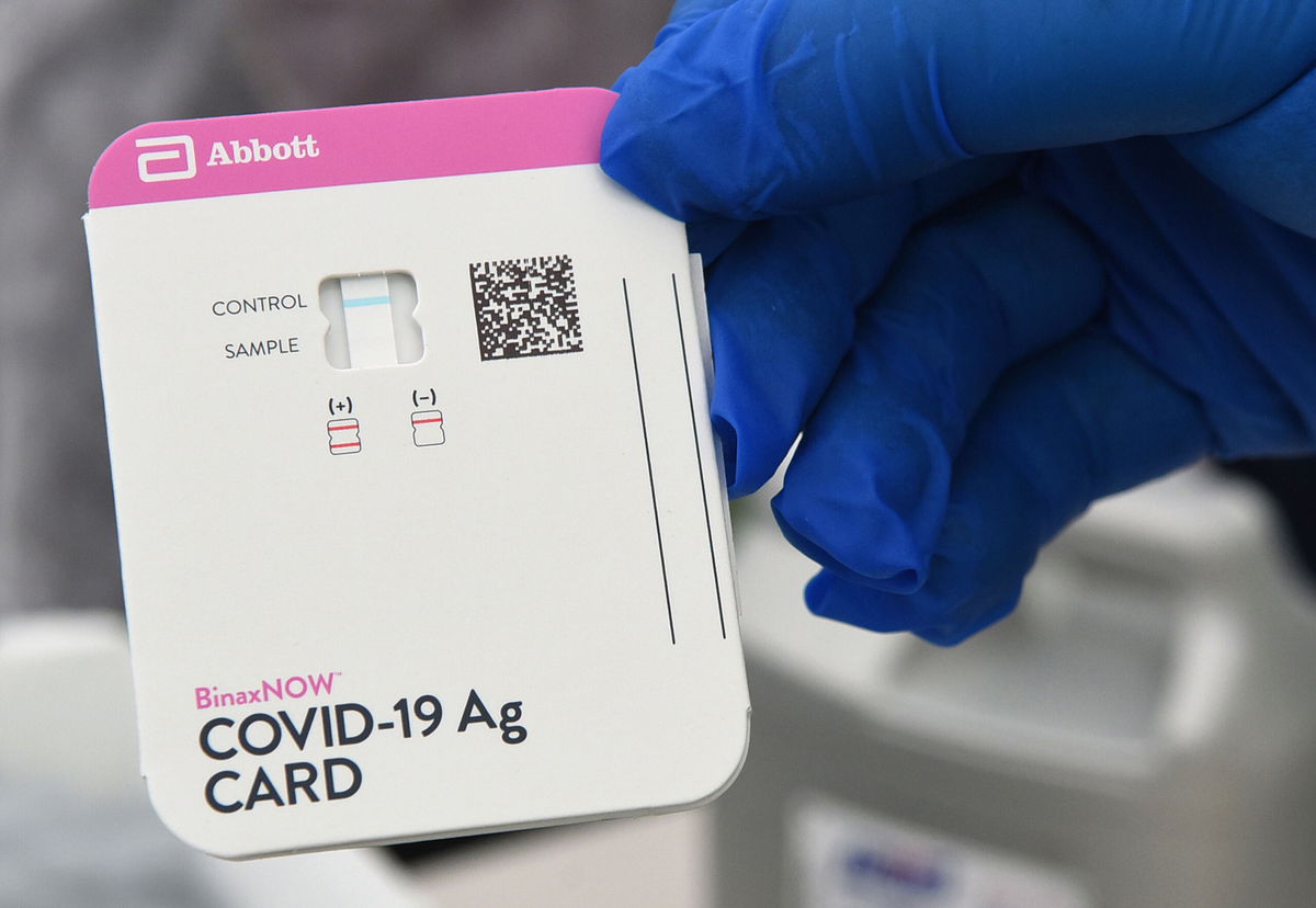 <i>Paul Hennessy/NurPhoto/Getty Images</i><br/>A health worker displays a Covid-19 rapid test kit at a drive through site at Barnett Park on November 9