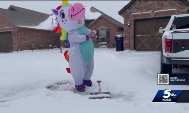 An Oklahoma music teacher dressed up in a unicorn costume to shovel snow.