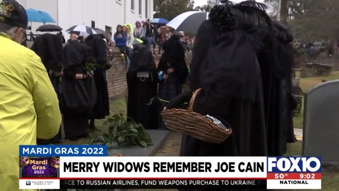 <i>WALA</i><br/>The Merry Widows surround he grave of Joe Cain