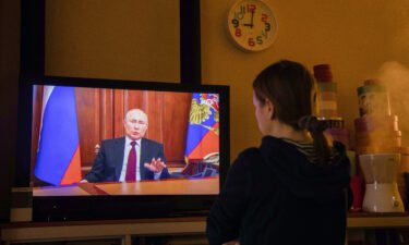 A resident watches a live broadcast of Russian President Vladimir Putin on Monday